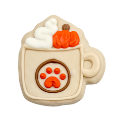 Decorative cookie shaped like a hot chocolate mug with pumpkins and a paw print on a white background